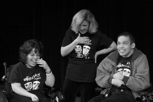 Three actors, two in wheelchairs, act in a skit