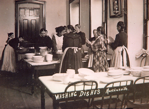 Women wash dishes in the dining room